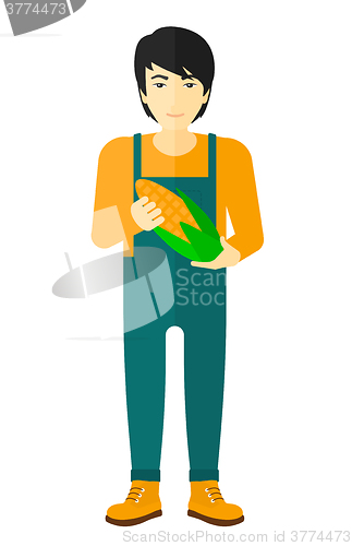 Image of Farmer holding corn.