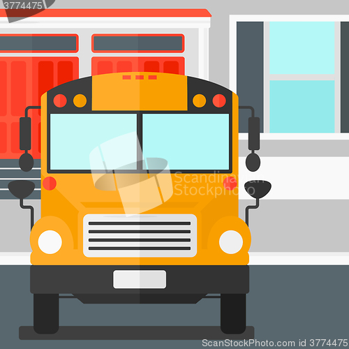 Image of Yellow bus on the background of school building.