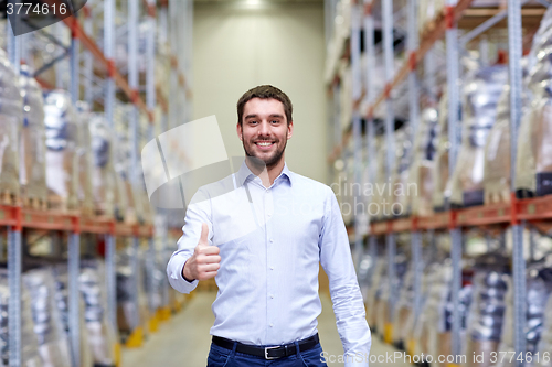 Image of happy man at warehouse showing thumbs up gesture