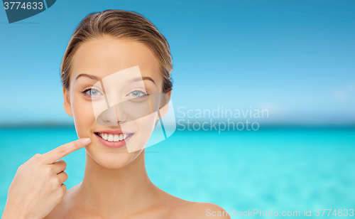 Image of smiling young woman face and shoulders