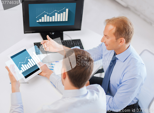 Image of businessmen with tablet pc and computer at office