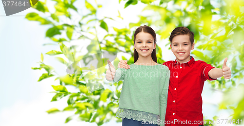 Image of happy boy and girl showing thumbs up