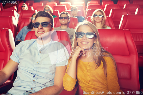 Image of happy friends watching movie in 3d theater