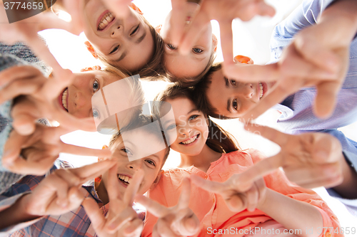 Image of happy children showing peace hand sign