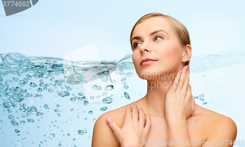 Image of young woman touching her neck