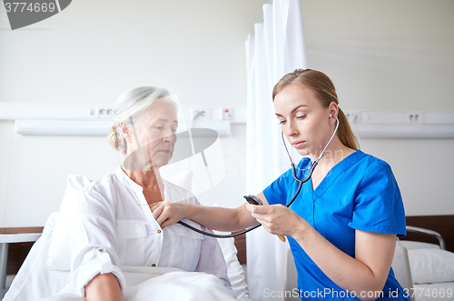 Image of nurse with stethoscope and senior woman at clinic