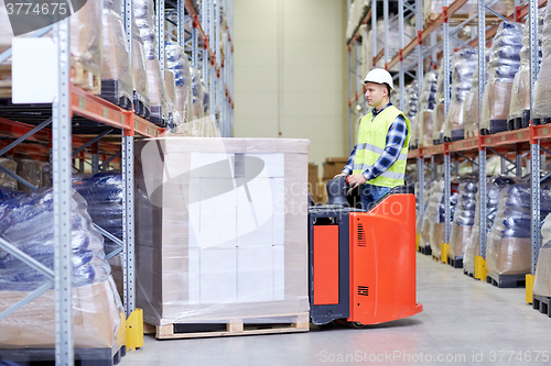 Image of man on forklift loading boxes at warehouse