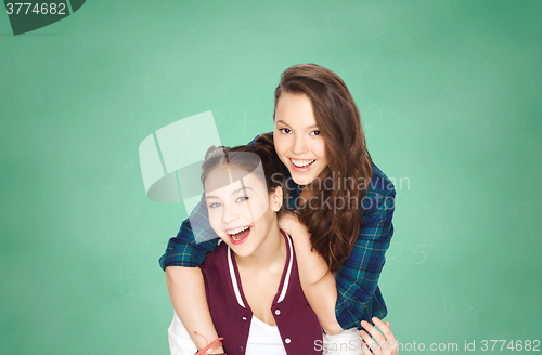 Image of happy teenage girls having fun over green board