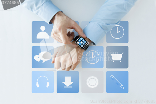 Image of hands with application icons on smart watch