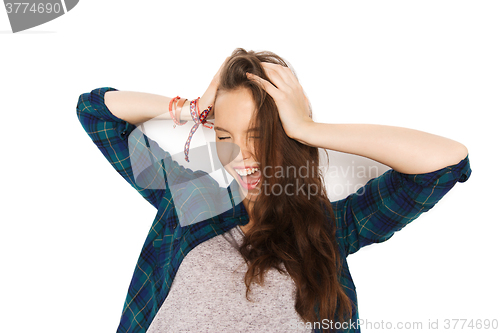 Image of happy pretty teenage girl holding to head