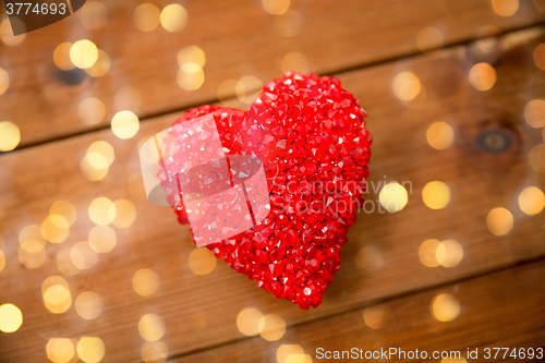 Image of close up of red heart decoration on wood