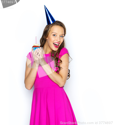Image of happy woman or teen girl with birthday cupcake