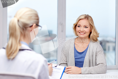 Image of smiling doctor and woman meeting at hospital