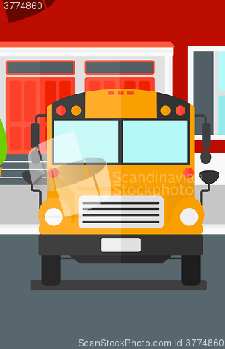 Image of Yellow bus on the background of school building.