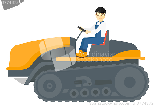 Image of Farmer driving catepillar tractor.