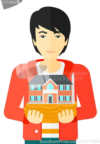 Image of Man holding house model.