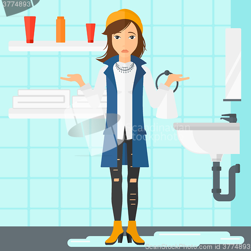 Image of Woman in despair standing near leaking sink.