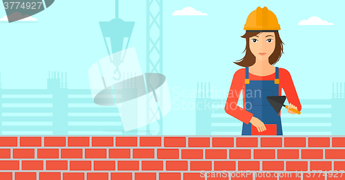 Image of Bricklayer with spatula and brick.