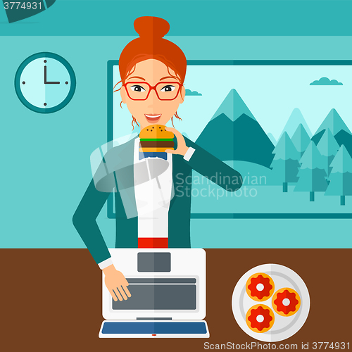 Image of Woman eating hamburger. 