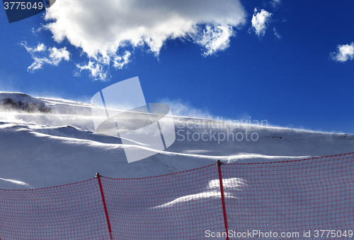 Image of Off-piste slope during a blizzard and sunlight blue sky