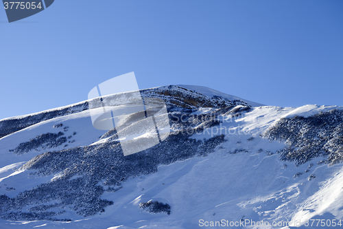 Image of Snowy mountains with track from avalanche after snowfall