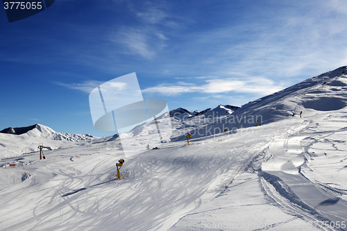 Image of Ski slope with snowmaking at sun morning