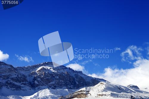 Image of Snowy rocks at sun day