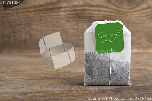 Image of Teabag on wooden background, get well soon