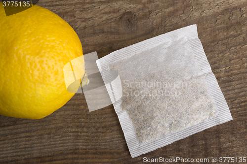 Image of Lemon teabag on wooden background