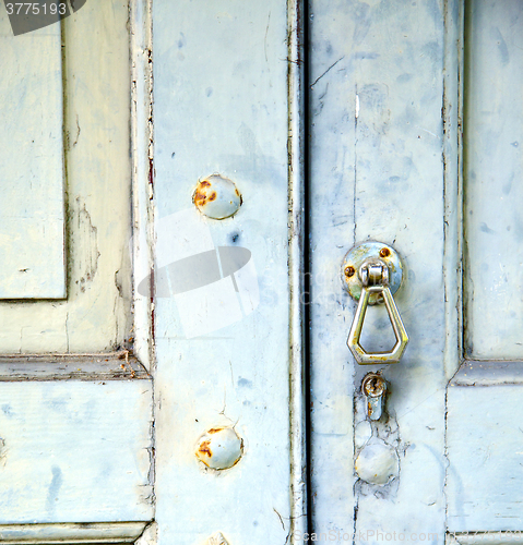 Image of abstract cross   brass brown knocker in   venegono  varese italy