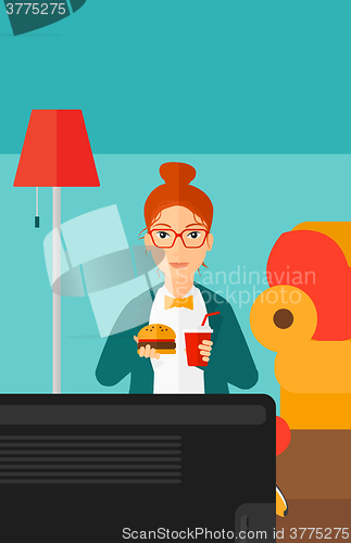 Image of Woman eating hamburger. 