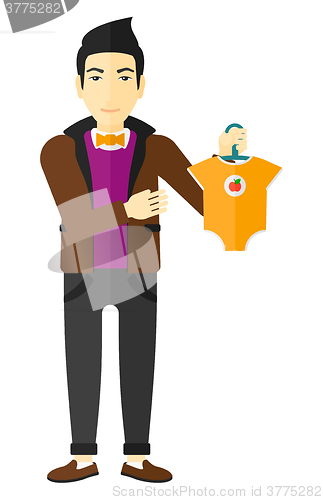 Image of Man holding clothes for baby.