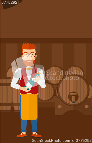 Image of Waiter holding bottle of wine.