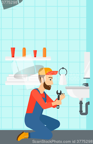 Image of Man repairing sink.