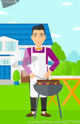 Image of Man preparing barbecue.