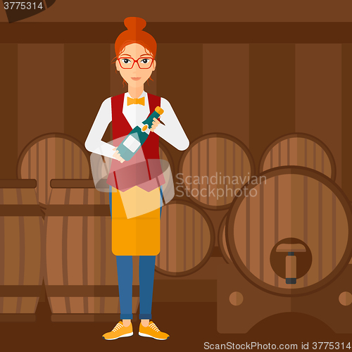 Image of Waitress holding bottle of wine.