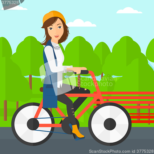 Image of Woman riding bicycle.