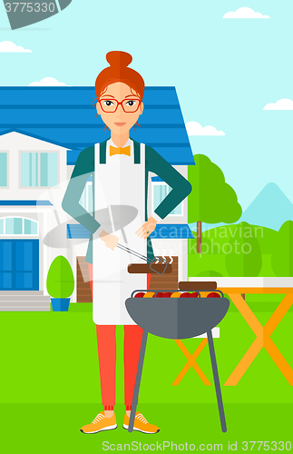 Image of Woman preparing barbecue.