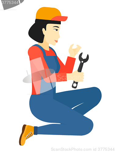 Image of Repairer holding spanner.