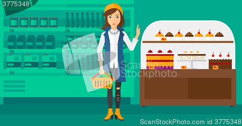 Image of Woman holding supermarket basket.