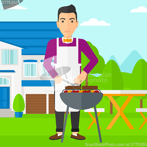 Image of Man preparing barbecue.