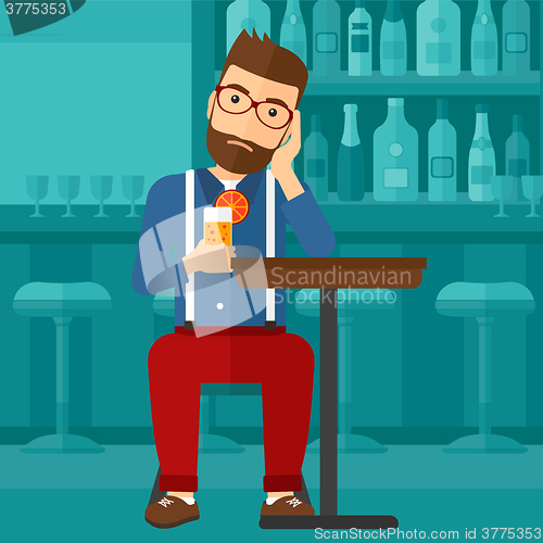 Image of Man sitting at bar.