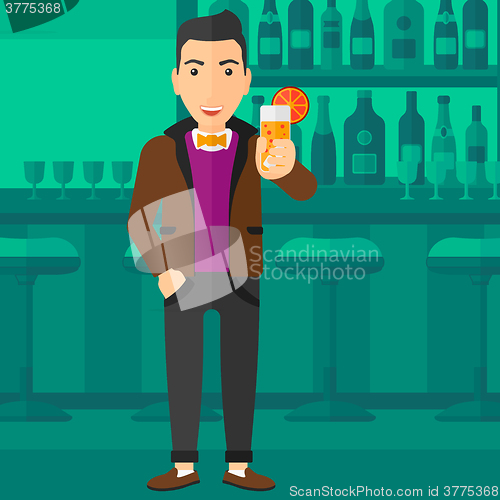 Image of Man holding glass of juice.