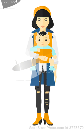 Image of Woman holding baby in sling.