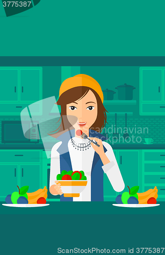 Image of Woman eating salad.