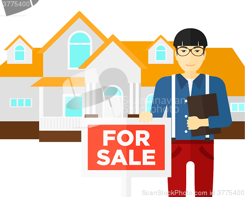 Image of Real estate agent offering house.
