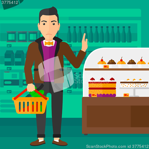 Image of Man holding supermarket basket.