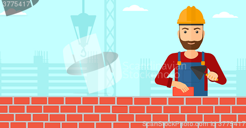 Image of Bricklayer with spatula and brick.