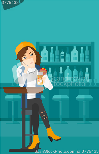 Image of Woman sitting at bar.