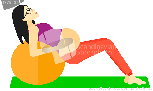 Image of Pregnant woman on gymnastic ball.